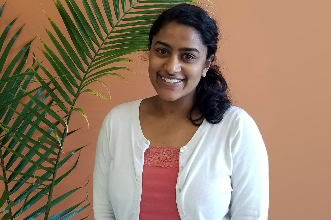 Rini smiling at Nesbitt Hall